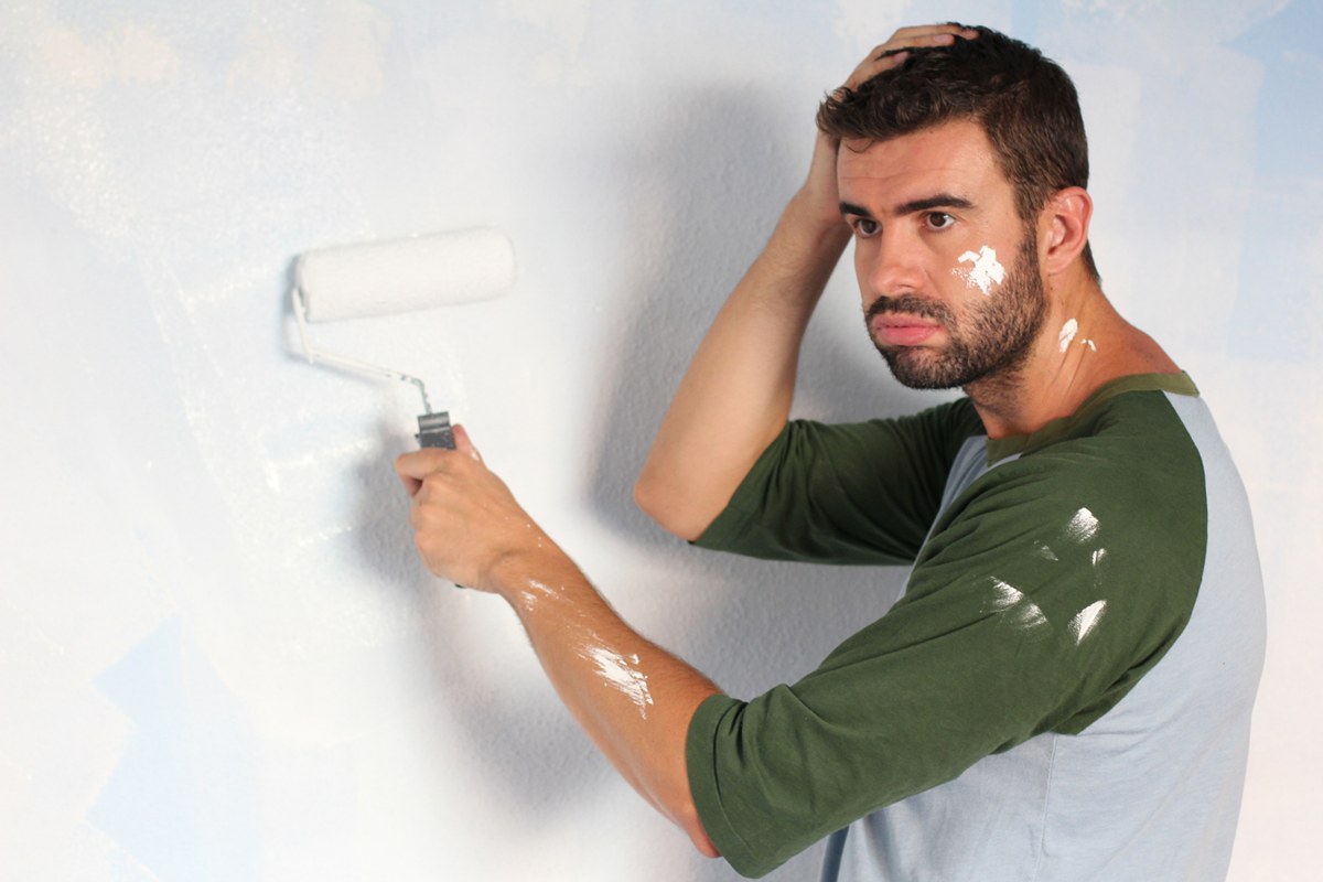 man wondering what went wrong with his painting project