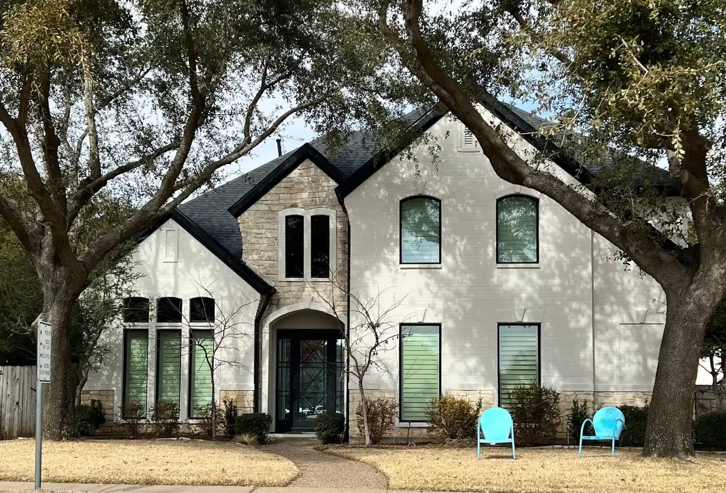 Modern White Brick House Exterior Painting Beautifully painted modern home with white brick and stone, showcasing expert exterior painting services for residential properties.